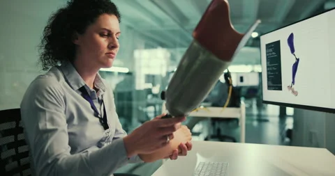 Research, development and woman at computer screen with prosthetic leg, planning Stock Footage 283663203