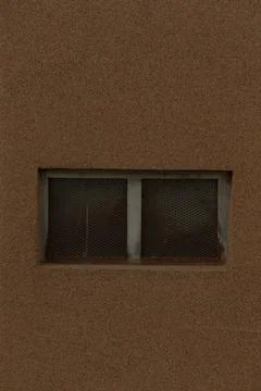 Research focusing on thin window integrated within weathered brick exterior Stock Photos