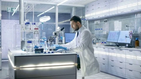 Research Scientist Adjusts Sample in a Petri Dish with Surgical Pincers  Video stock 75412686