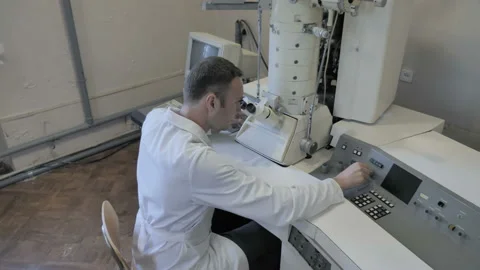 Research Scientist Looking Through Microscope In Laboratory Stock Footage 156749032