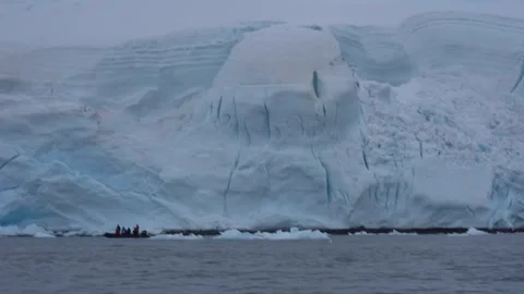Research Team Aboard a Zodiac Exploring the Antarctic Coast Stock Footage 339610992