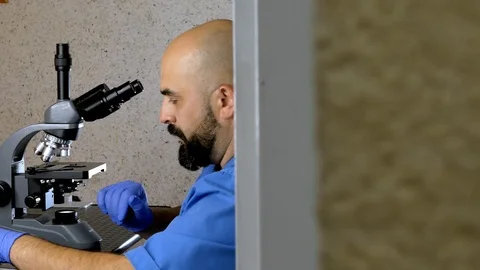 Research using a microscope. Stock Footage 117624054