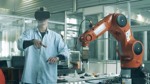 Research worker is managing a robotic arm virtually Stock Footage 131549454