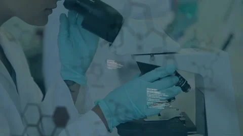 Researcher adjusting microscope focus while molecular code overlay guiding Stock Footage 313148584