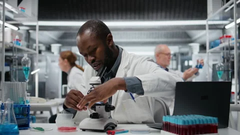 Researcher analyzing genetic samples with high tech microscopic equipment Video stock 326262949