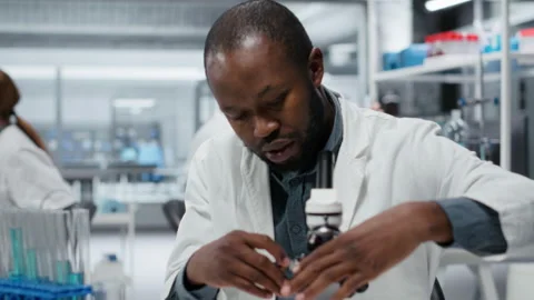 Researcher analyzing genetic samples with high tech microscopic equipment Video stock 327244542