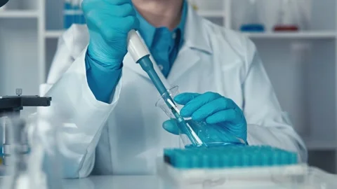 A researcher in a biochemistry lab is immersed in the study of chemical Stock Footage 267839783