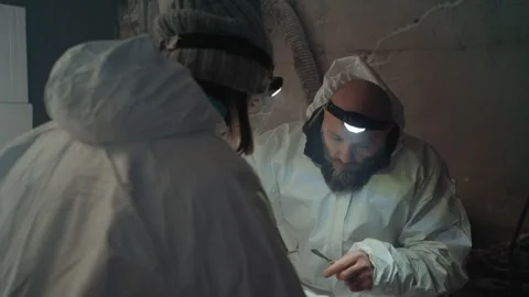 Researcher in hazardous environment pausing. Scientist in safety suit carefully 動画素材 342744254