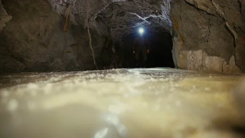 A researcher with a lantern goes on ice in the drift of an abandoned mine. Stock Footage 86076152