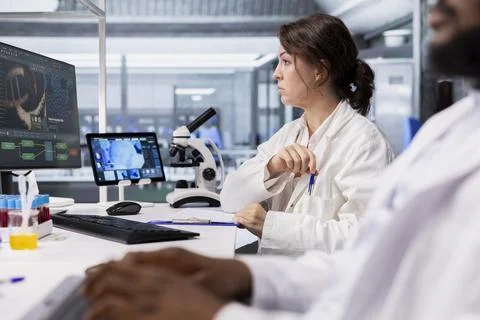 Researcher looking at 3D molecular model visualization on computer 写真素材