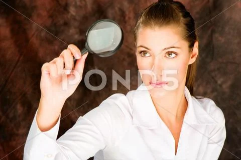 Researcher looking through magnifier glass Stock Photos