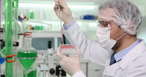 Researcher Man Use Micro Pipette Dropping Test Solution Laboratory in Microplate Stock Footage