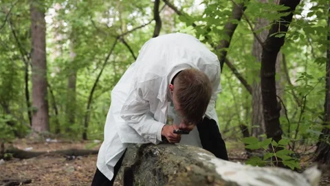 Researcher Observing Fallen Stump with Microscope in Forest Stock Footage 321113382