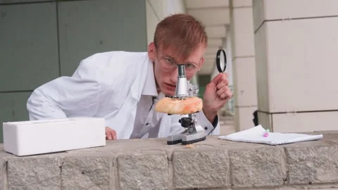 Researcher Observing Pastry With Microscope Outdoors Stock Footage 321118351