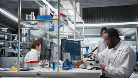 Researcher operating compound microscope, doing sample observation Stock Footage 320741111