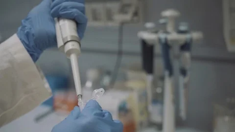 Researcher pipetting DNA sample into eppendorf vial in laboratory Video stock 126974937