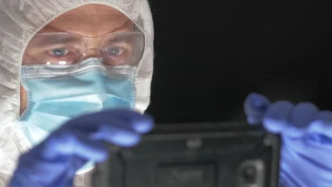 Researcher in protective suit using mobile phone for scientific research. Sel Stock-Footage 156438287