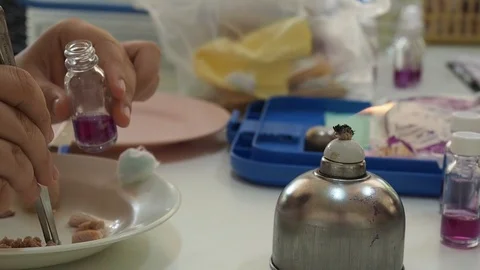 The researcher put a pieces of meat samples into a test bottle Stock Footage 92593591