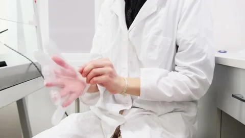 Researcher puts on protective gloves Stock Footage 148422830