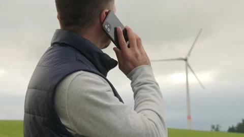 Researcher reports about functioning wind turbine on phone Video stock 205710177