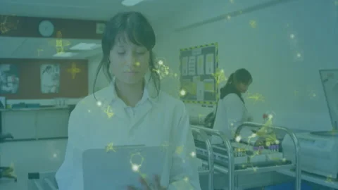 Researcher reviewing tablet data with molecular overlay pulsing as colleague Stock Footage 310282691