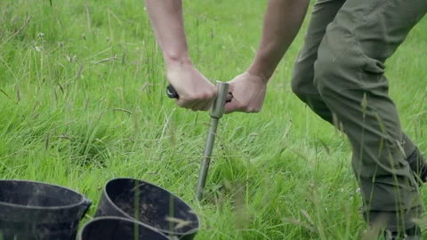 Researcher taking a soil core sample for scientific analysis Stock Footage 340546120