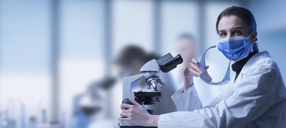 Researcher using a microscope in the lab Stock Photos