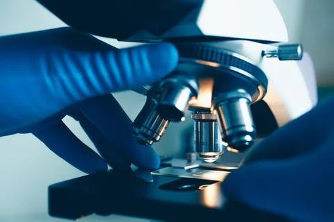 Researcher using optical microscope in lab Stock Photos