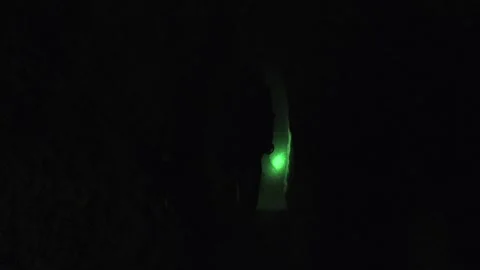 Researcher walks deep inside cave passage, lone explorer moving - Cave Interior Stock Footage 339817672