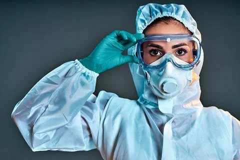 Researcher wearing hazmat protective suit and safety goggles. Stock Photos