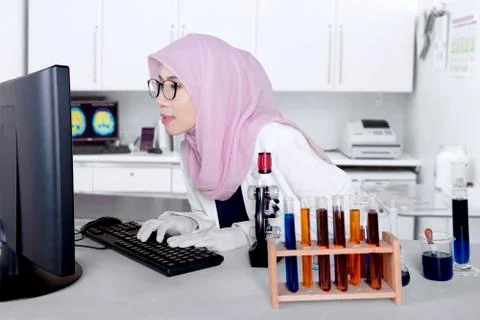 Researcher working on computer in the lab Stock Photos