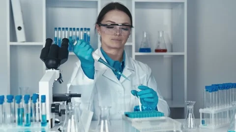The researcher is working to develop a new treatment using cutting-edge Stock Footage 257622466