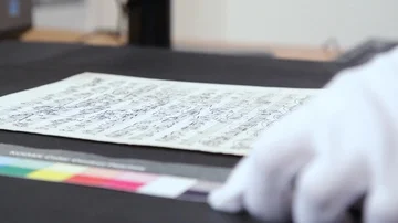Researcher working on an original old hand writed music sheet Stock Footage 85885766