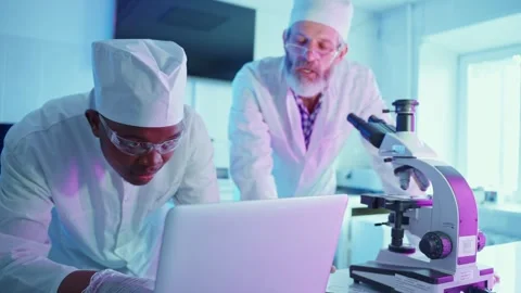 Researchers Analyzing Samples in a Modern Laboratory Setting Stock Footage 284413477