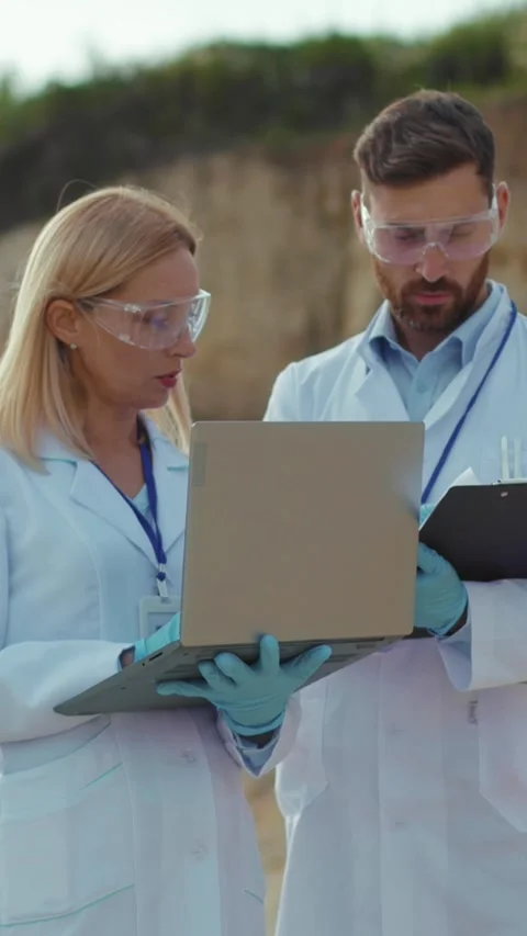 Researchers and scientists dedicatedly analyzing data accumulated in a field Stock Footage 314207417