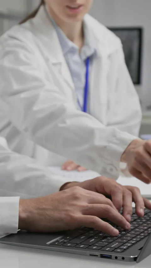 Researchers Collaborating at Workstation, Operating Laptop in Laboratory Stock Footage 321898509