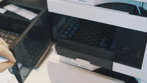 Researchers hands put sample experiment into laboratory machine Video stock 158527212