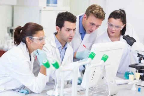 Researchers looking at computer screen in the lab Stock Photos