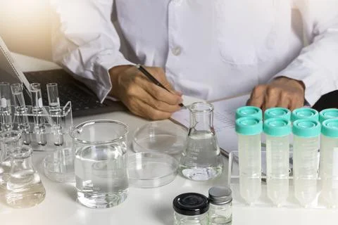 Researchers study data and conduct chemical experiments, in the creation of.. Stock Photos