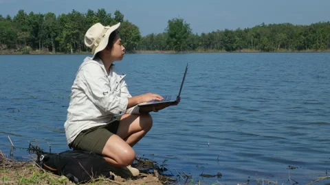 Researchers use laptops to record pathogen analysis in natural waters. Stock Footage 226480540
