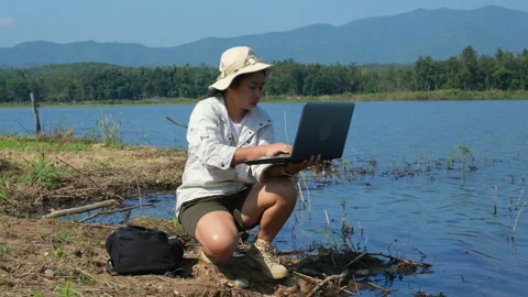 Researchers use laptops to record pathogen analysis in natural waters. 動画素材 226480689