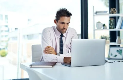 Researching is step one in solving problems. a businessman sitting with his Stock Photos
