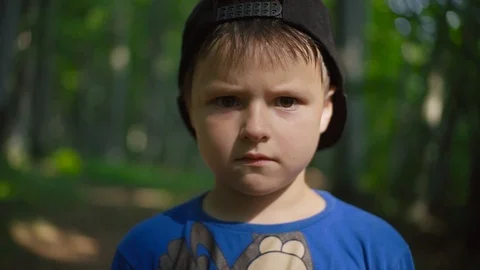 Resentful little boy in black cap looking at camera. Portrait of Caucasian child Stock Footage 95934880