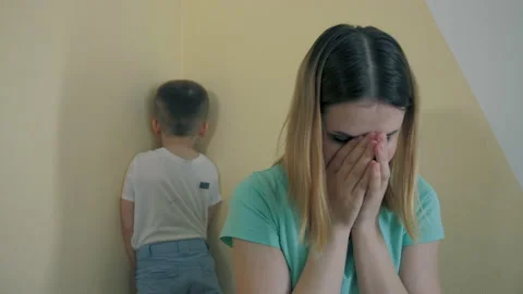 Resentment and quarrel between mom and little son, sit back to back, closes ears Stock Footage 187171641