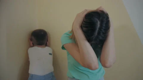 Resentment and quarrel between mom and little son, sit back to back, closes ears Stock Footage 187983250