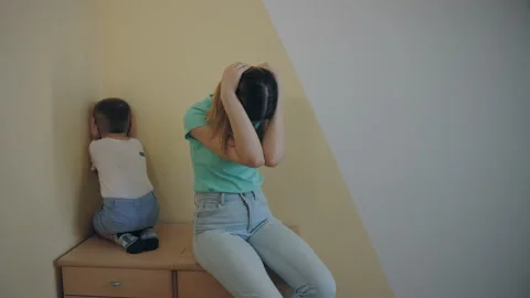 Resentment and quarrel between mom and little son, sit back to back, closes ears Stock Footage 187983852