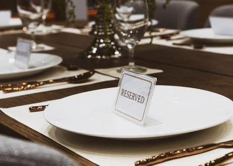 Reservation on a dinner table at the restaurant, plate reserve Stock Photos