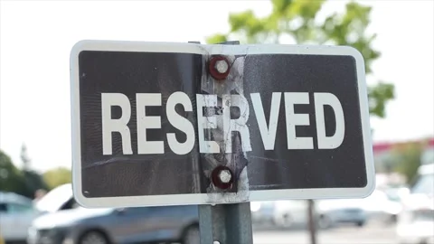 Reserved horizontal rectangle black white sign on metal post with parking lot Stock-Footage 251365306