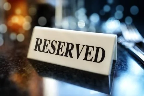 Reserved sign on restaurant table Stock Photos