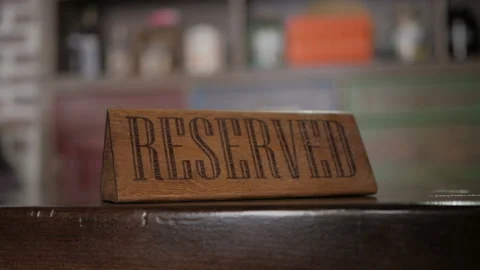 Reserved - a sign on the table in restaurant. Clouse up. Plate - reserved. Stock Footage 109220936